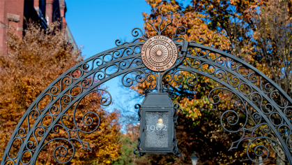 Colorful fall trees seen through the Class of 1902 gate